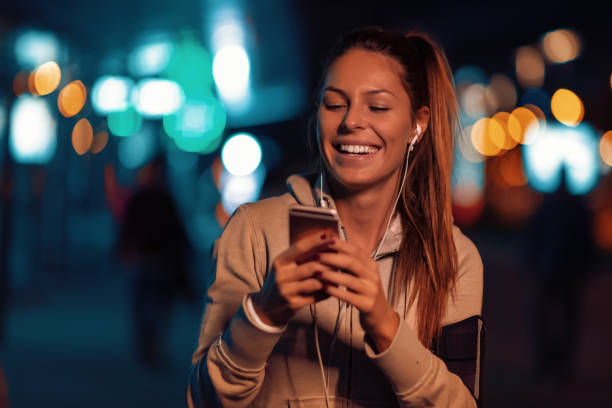 istock Happy girl relaxing after training at night 1076258044