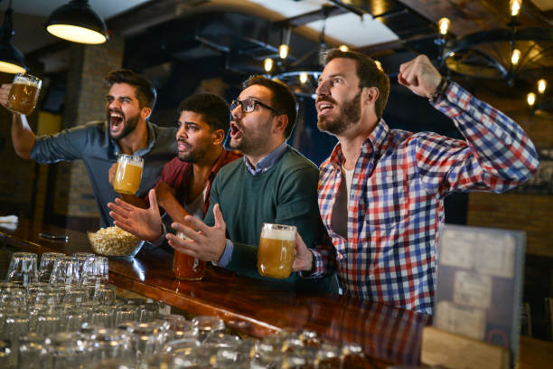 istock Friends in bar watching game 1076262994