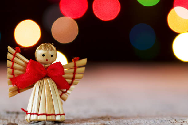 istock angel in front of christmas lights 1076266020
