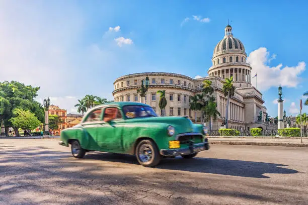 Green vintage car in front of Capitolio, Havana, Cuba