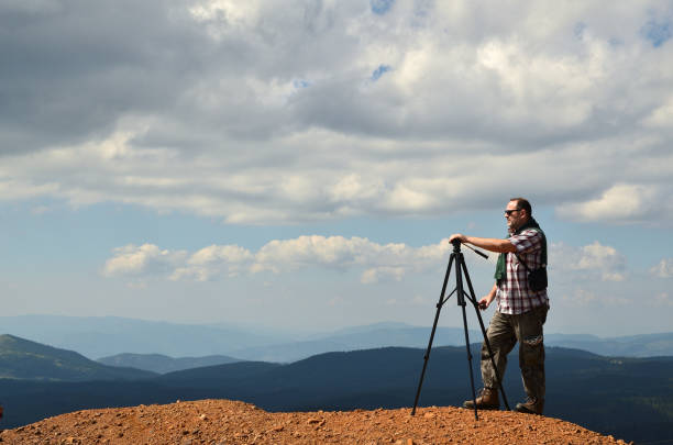istock Man preparing to shoot a landscape 1076278242