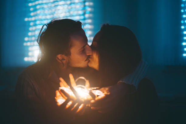 istock Young couple and Christmas lights 1076300916