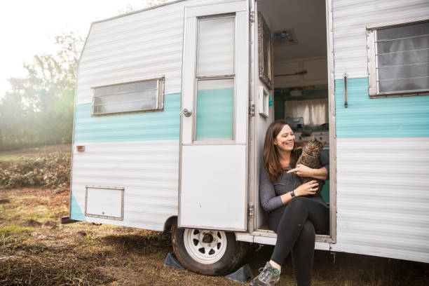 Woman Camping in Trailer with her Cat