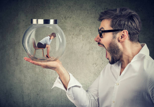 hombre gritando con tarro de cristal con la mujer en el interior - embarrassment men business guilt fotografías e imágenes de stock