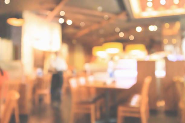 istock Restaurant interior with customer and wood table blur abstract background with bokeh light 1076327242