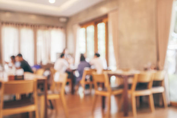 istock Restaurant interior with customer and wood table blur abstract background with bokeh light 1076327266