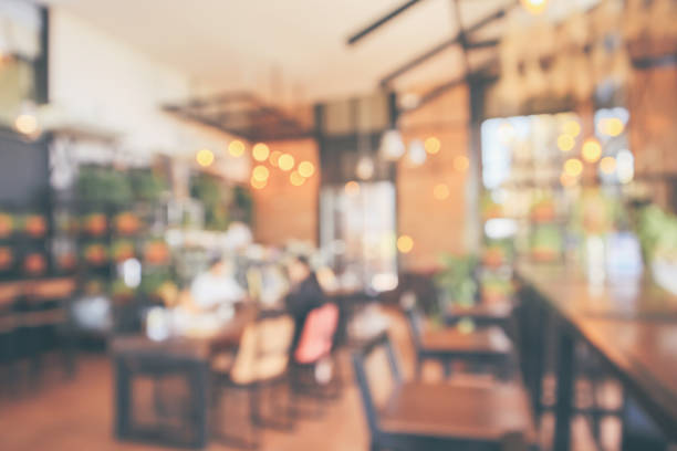 istock Restaurant cafe or coffee shop interior with customer blur abstract vintage style bokeh light for montage product display background 1076327348