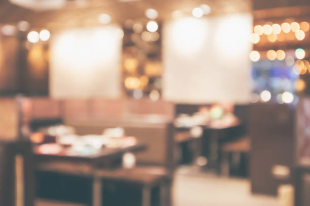istock Restaurant cafe or coffee shop interior with customer blur abstract vintage style bokeh light for montage product display background 1076327354
