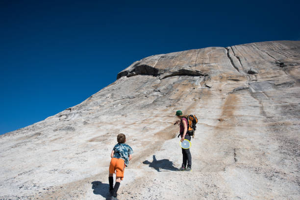 istock Mother and son on a steep hike 1076328324