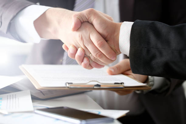 istock Man in suit shake hand as hello in office 1076328896