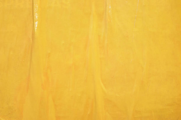 istock Blank yellow old ripped torn paper crumpled creased posters grunge textures backdrop backgrounds placard 1076331556