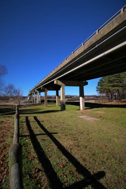 istock A Park Fence Borders the Bridge Structure Crossing the Arkansas River at the Toad Suck Ferry Lock and Dam 1076340120