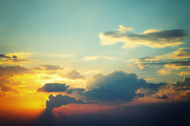 istock morning sky, sunlight shining on dark clouds and sky background 1076355152