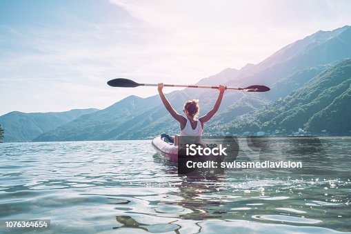 istock Happy woman loving canoeing on lake in Summer 1076364654