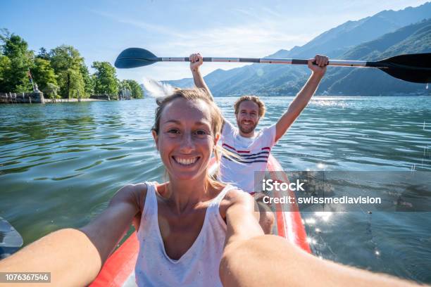 Young Couple Taking Selfie Portrait In Red Canoe On Mountain Lake Stock Photo - Download Image Now