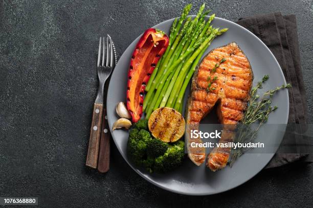 Tasty And Healthy Salmon Steak With Asparagus Broccoli And Red Pepper On A Gray Plate Diet Food On A Dark Background With Copy Space Top View Flat Lay Stock Photo - Download Image Now