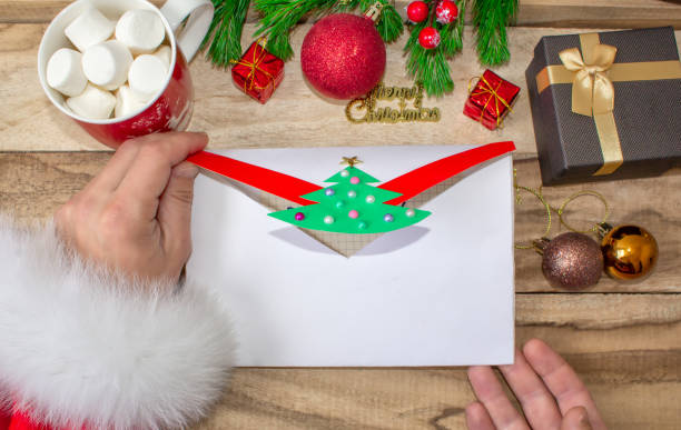 istock Santa opened the child handmade envelope for Christmas wish list 1076375652