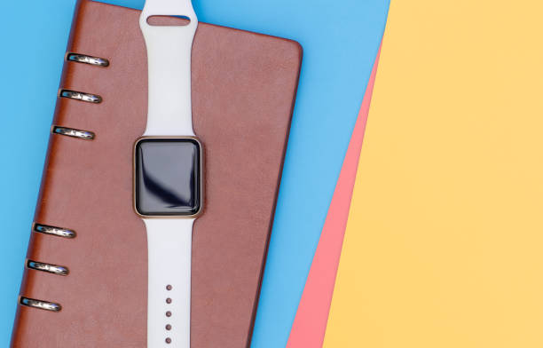 istock Smart watch on notebook for organize concept with blue pink yellow 1076383786
