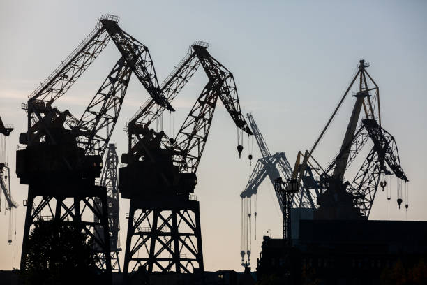 istock Silhouette shipyard have crane machine, Shipyard industry. 1076406256