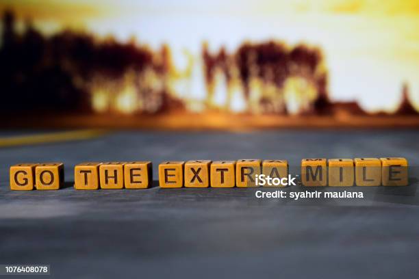 Go The Extra Mile On Wooden Blocks Stock Photo - Download Image Now - Dedication, Service, Effort