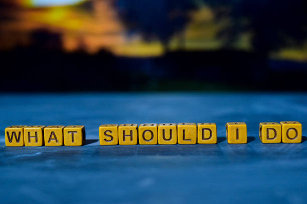 istock What should I do? on wooden blocks. 1076409442