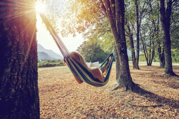 Hammock with straw hat with palm trees at sunset in tropical hotel . Cuba, Varadero, summer vacation concept