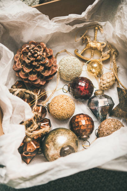 istock Christmas tree decoration toys and cones in box, vertical composition 1076471810