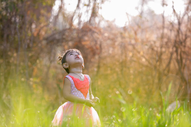 istock indian child playing in wheat field 1076473584