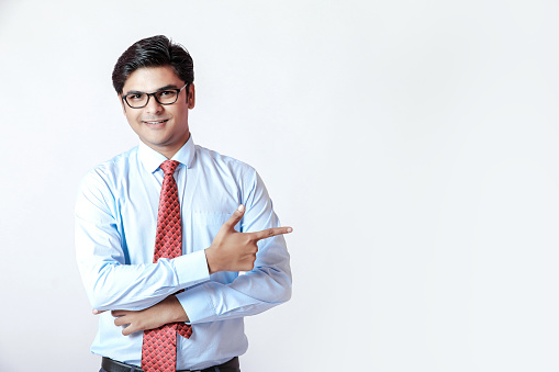 Young Indian businessman over white background