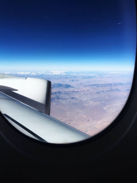 istock Desert from airplane view during fly.  Sand mountain and some snow covered on so far mountain. A contrast of dark blue sky and brown sand. Horizon of nature background. 1076480152