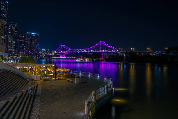 istock Glowing bridge in cityscape in night time 1076480596