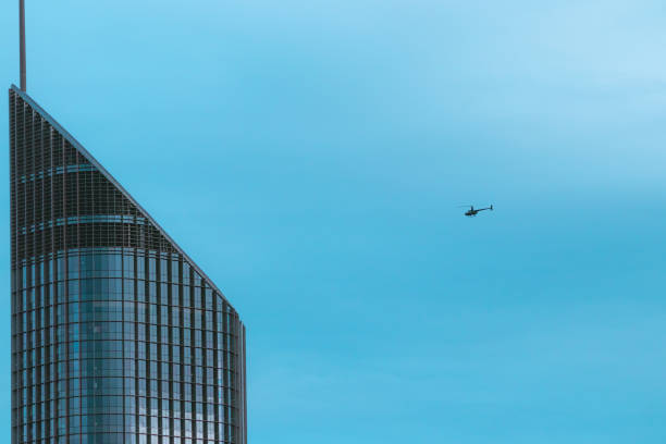 istock Helicopter flying near skyscraper 1076480838