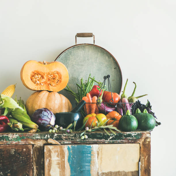 istock Fall vegetarian food ingredients variety on rustic cupboard, square crop 1076486388