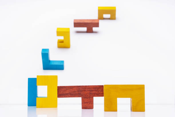 istock Abstract Background. Different colorful shapes wooden blocks on white background. 1076494824