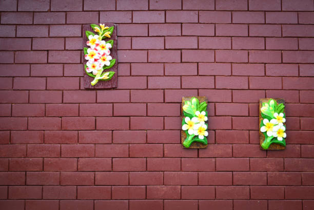 brick wall texture background / red brown brick pattern with seramic flower brick wall texture background / red brown brick pattern with seramic flower hang on the wall decorate seramic stock pictures, royalty-free photos & images