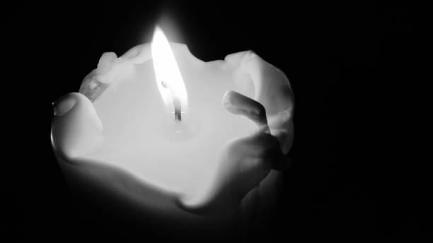 istock Flame of a candle on a black background, a candle is burning 1076497638