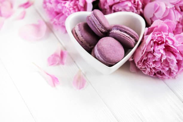 istock Pink peony flowers with macarons 1076500846