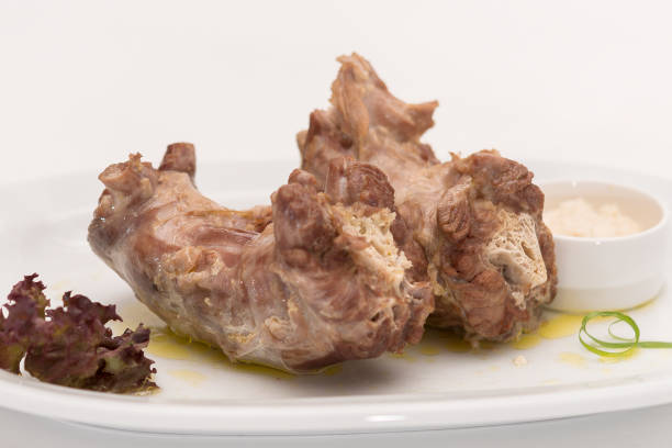 istock Turkey necks,  served with horseradish puree,  placed on white plate,  light background,  isolated 1076502598