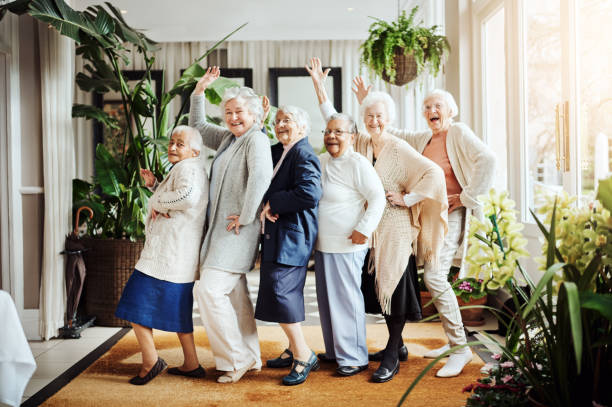 We found the fountain of youth…it’s called having fun! Portrait of a group of happy senior women having fun together at a retirement home geriatrics stock pictures, royalty-free photos & images