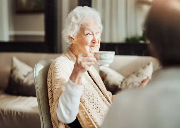 Portrait of happy senior women having tea together at a retirement home