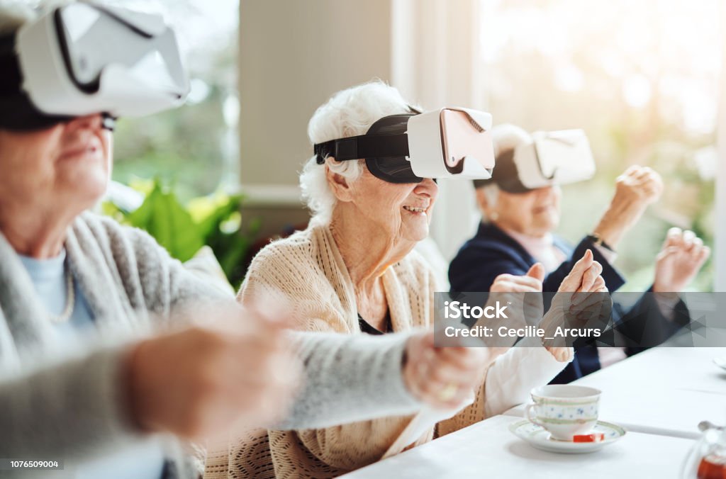 Revolutionising what retirement means with virtual reality Shot of happy senior women using virtual reality headsets together at a retirement home Senior Adult Stock Photo