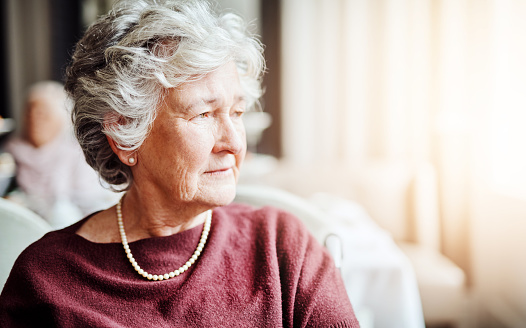 Shot of senior woman looking thoughtful in a retirement home