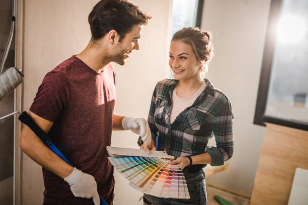 istock Happy couple talking while choosing colors for their new apartment. 1076510838