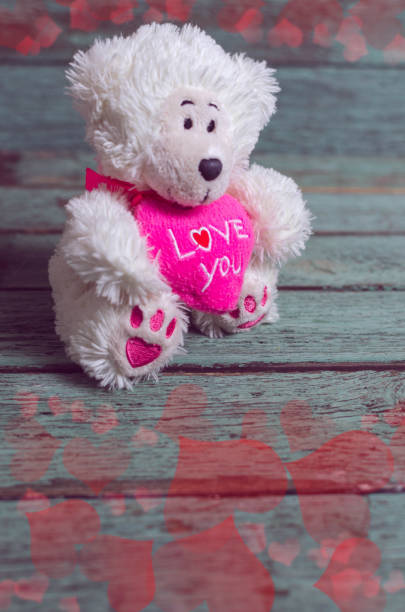 istock Valentin's day card with teddy bear and heards on rustic wooden background. 1076511288