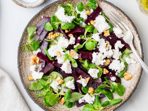 istock beetroot salad with feta, cheese, walnuts, corn salad on white table, top view 1076511652