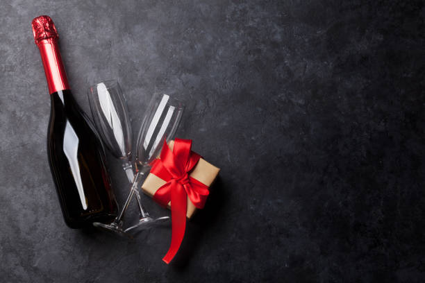 istock Champagne bottle, glasses and gift 1076517478