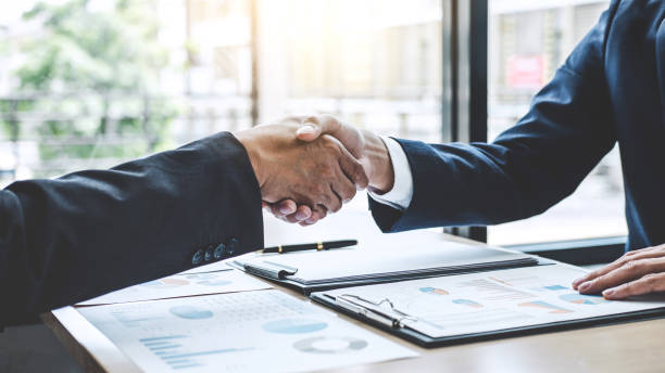 istock Teamwork partnership meeting concept, Two confident Business shaking hands after discussing good deal of trading contract and new projects for both companies 1076517734