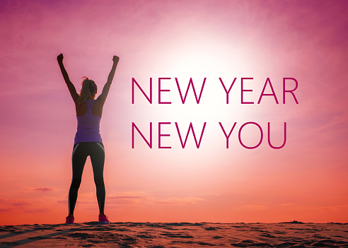 New year new you text quote on the image of unrecognizable woman's silhouette at sunrise.
