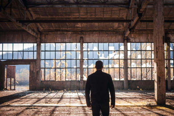 istock Handsome Man walk thru the Empty Factory 1076528964