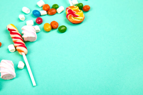 istock Colorful candies on pastel turquoise background. Flat lay 1076531832